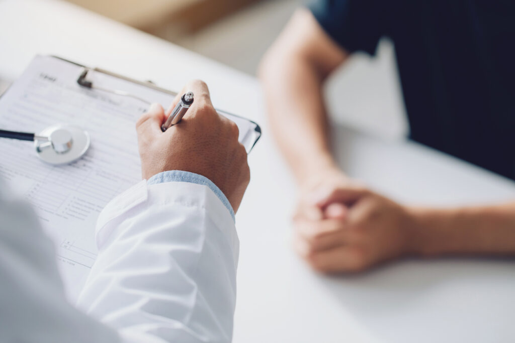 doctor holding test results and consulting patient at desk medic