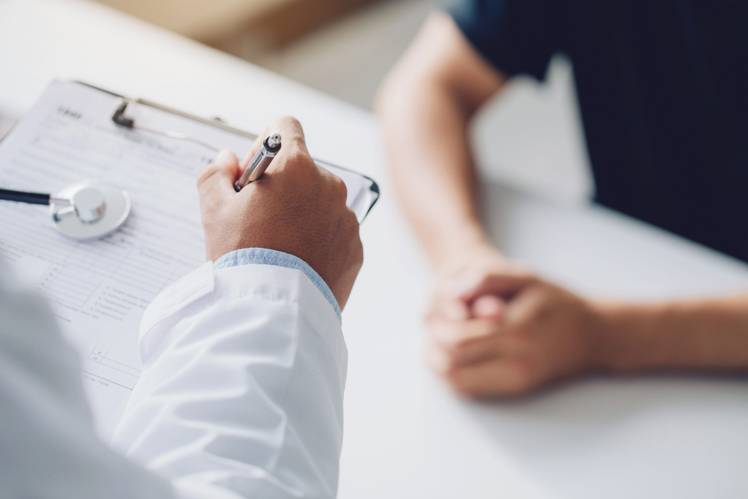 doctor holding test results and consulting patient at desk medic